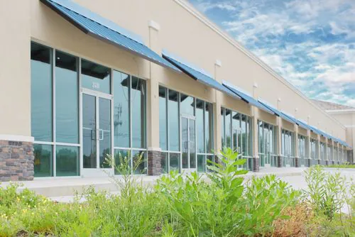 Office complex image with weed over growth